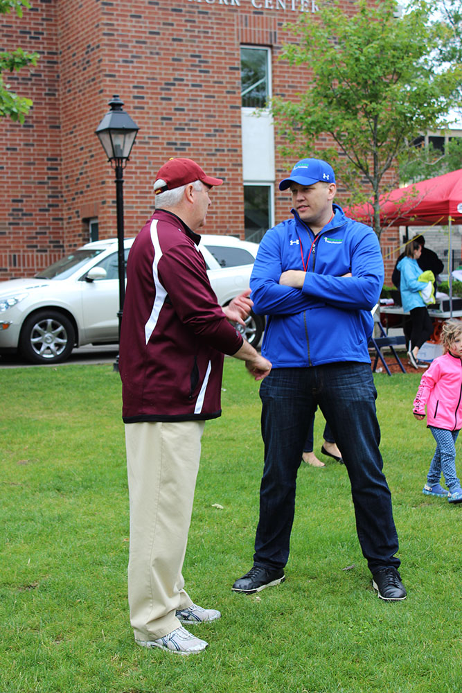 Chris speaking with the coach of Northborough-Southborough Youth Lacrosse