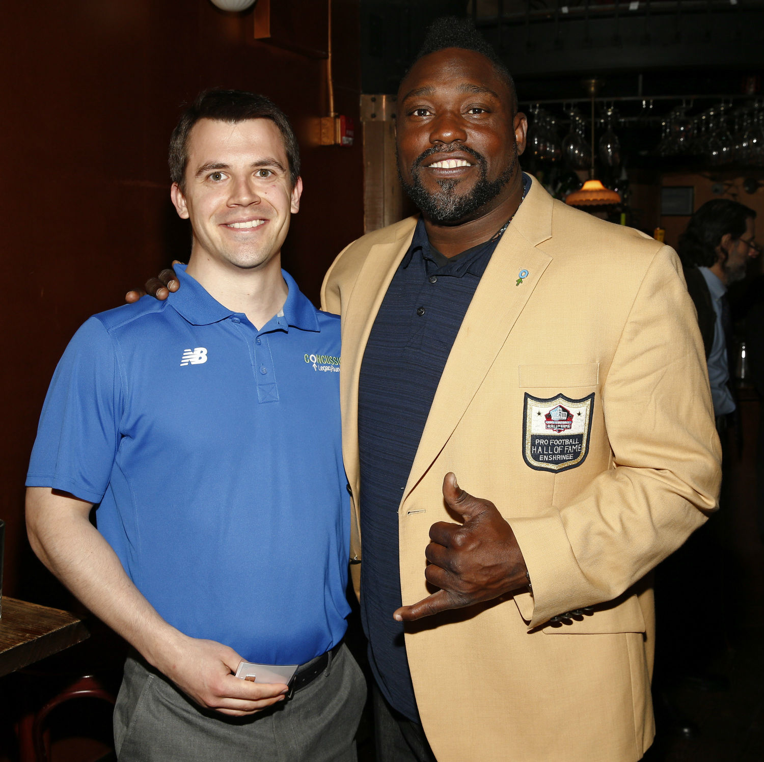 Foundation Director of Marketing and Communications Tyler Maland with Pro Football Hall of Famer Warren Sapp.