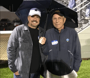 John Lantz and his son smile under an umbrella