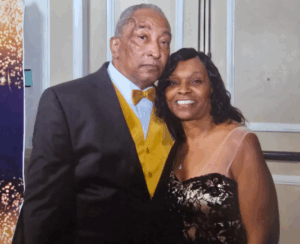 Former NFL player and Legacy Donor Cornell Webster in a suit next to his wife Jan