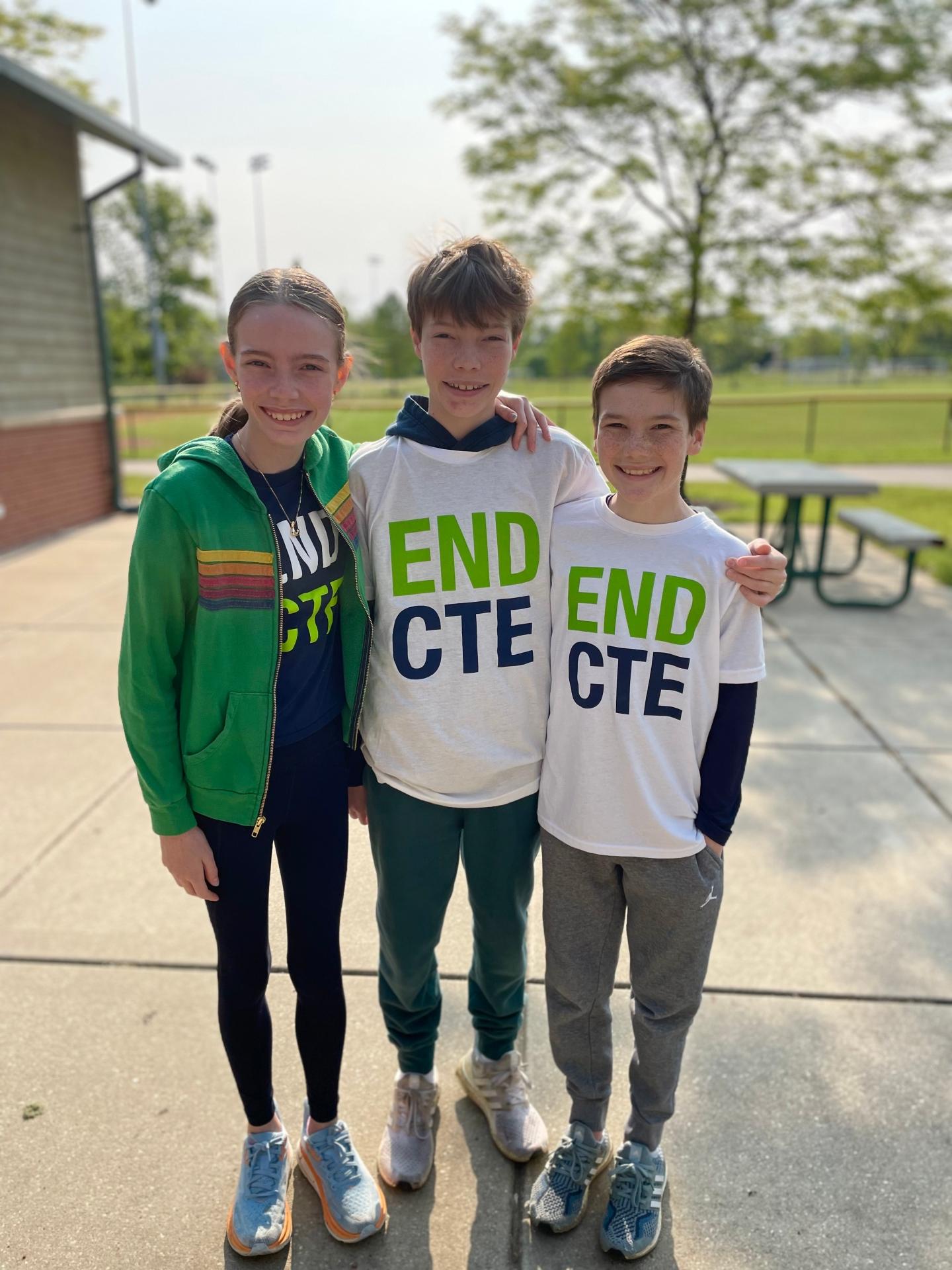 Three young children in End CTE tshirts at a Race to End CTE event